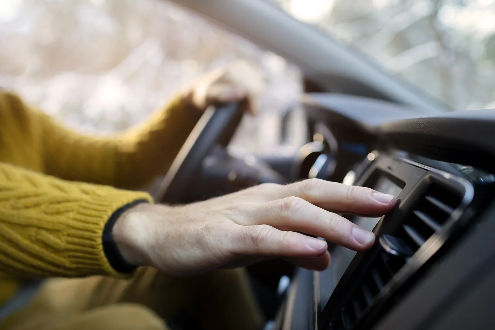 Close-up of hand holding steering wheel